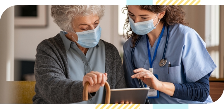 An elderly woman and a female doctor, who holds a tablet computer in her hand and discusses test results with the old woman